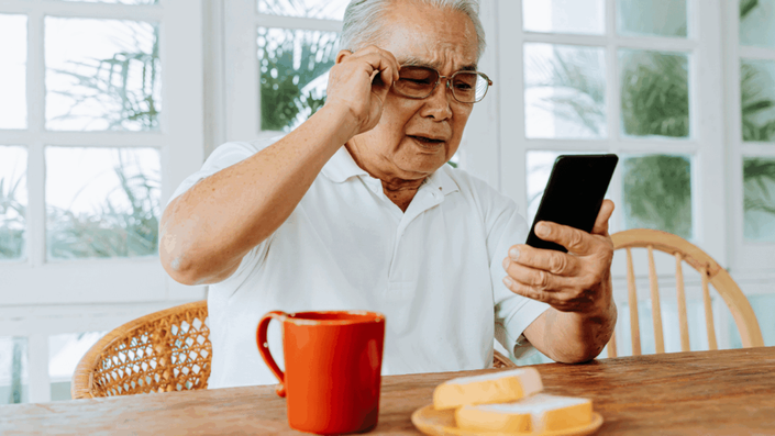 Senior man accessing financial services on a smartphone, demonstrating the accessibility of Cloud Banking for all age groups.