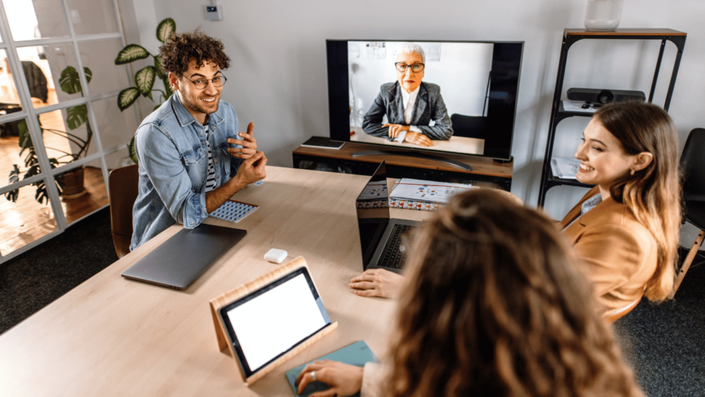 Entrepreneur managing a Hybrid Work team through a digital dashboard for enhanced remote collaboration.
