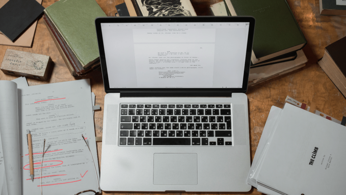 Laptop on a desk with business registration forms for starting as a Micro Entrepreneur in France.