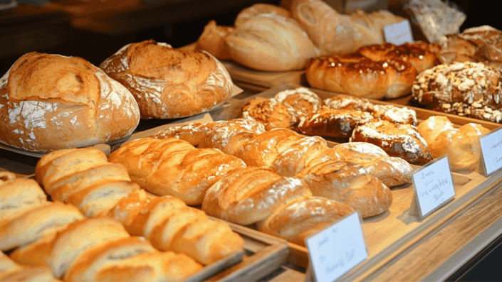 A French boulangerie with price tags on bread and pastries, illustrating the rising Cost of Living for daily needs in France.